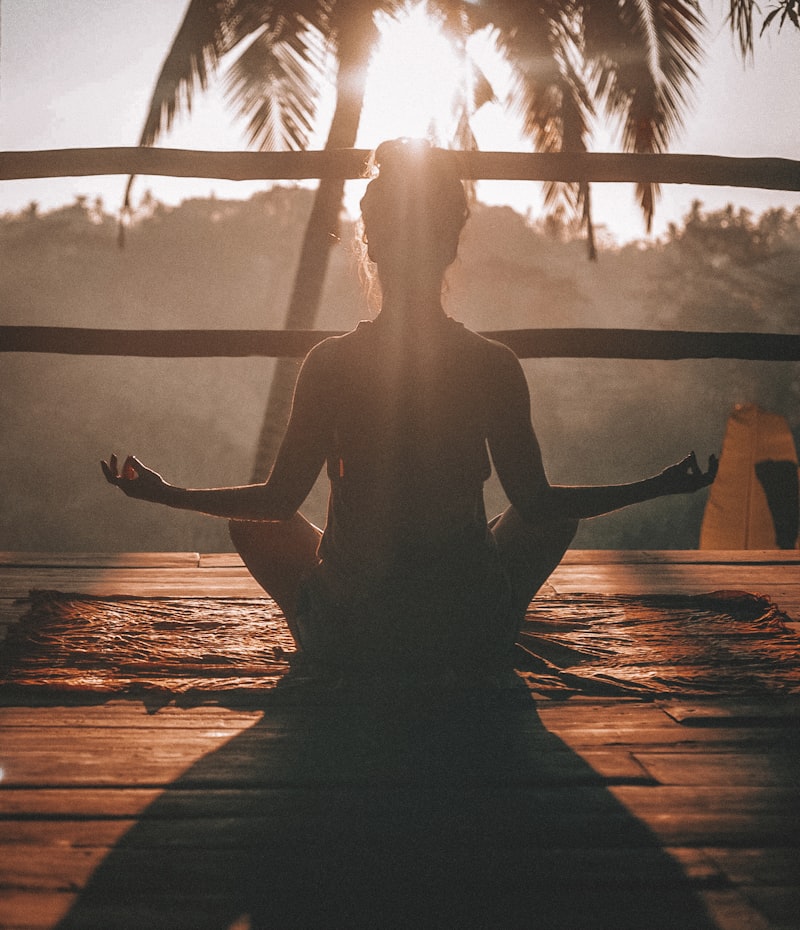 Person meditating in calm indoor light representing steady breath and mindful pacing.